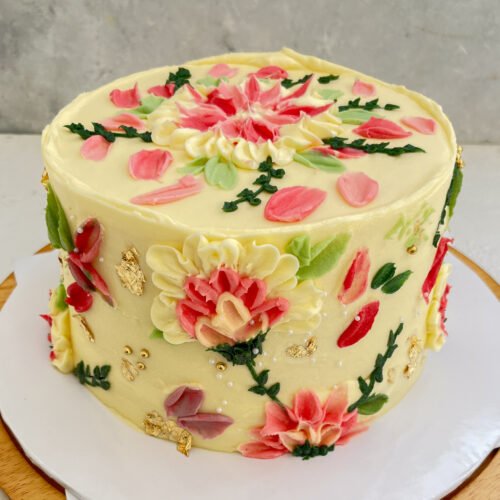 ribbon cake covered in butter icing and decorated with palette embossed flowers