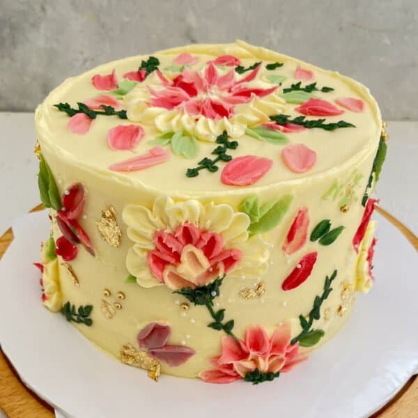 ribbon cake covered in butter icing and decorated with palette embossed flowers